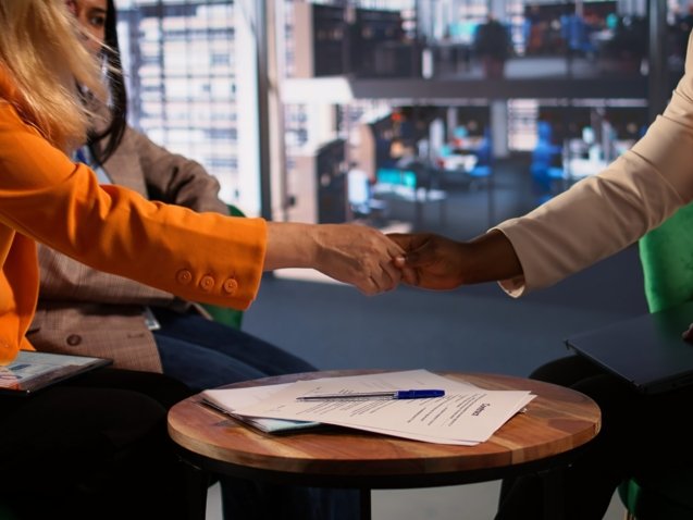 Women entrepreneurs finalize a business deal by signing paperwork, highlighting leadership and career progression in a global corporation. Powerful women sign a legal contract. Close up. Camera B.
