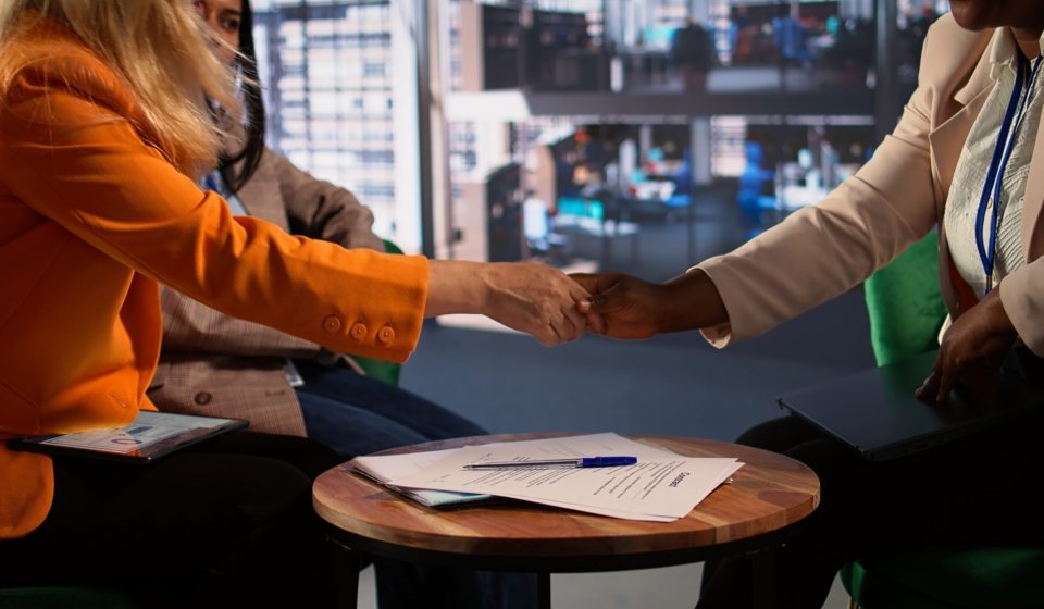 Women entrepreneurs finalize a business deal by signing paperwork, highlighting leadership and career progression in a global corporation. Powerful women sign a legal contract. Close up. Camera B.